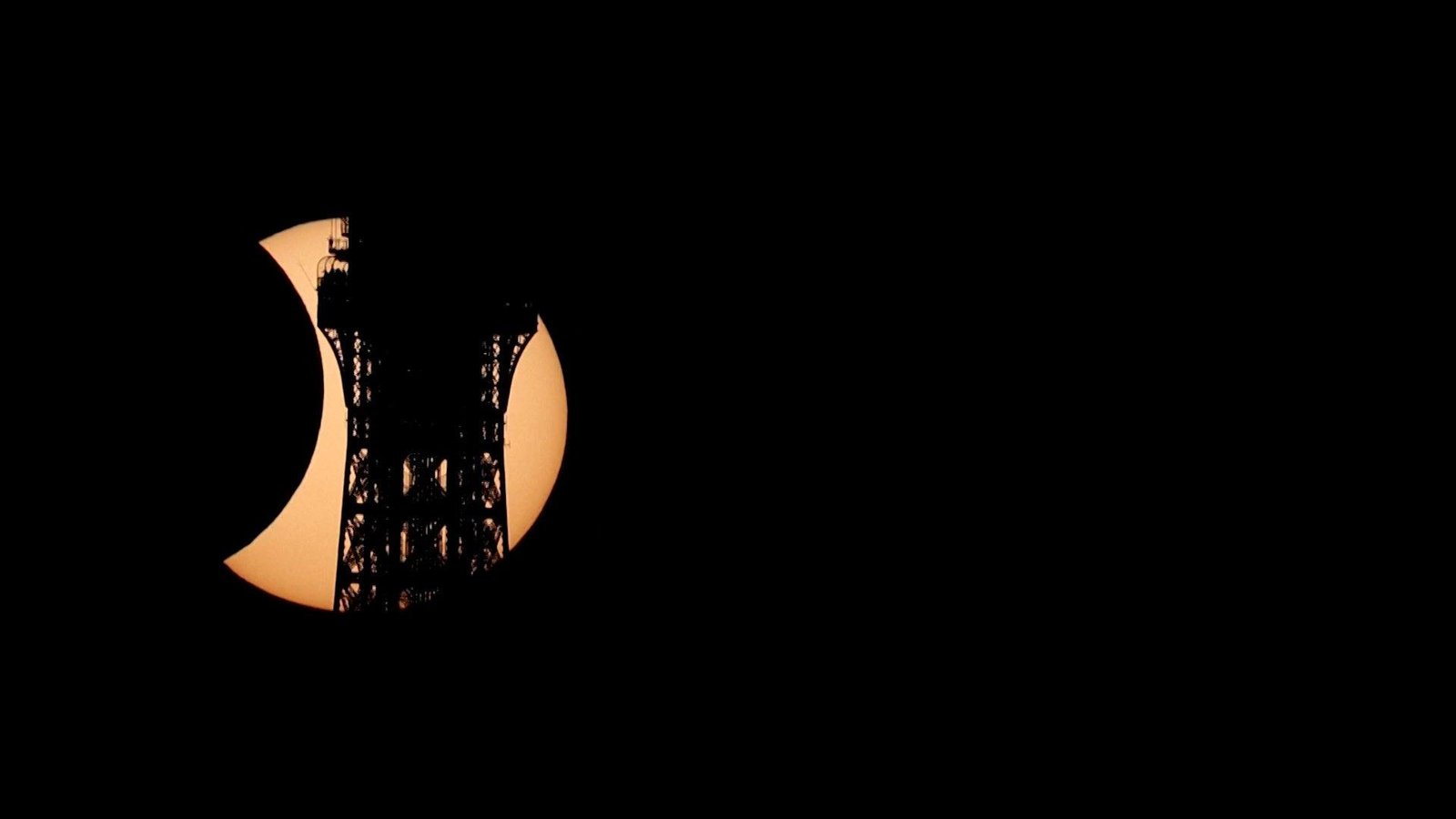 Solar eclipse carves Eiffel Tower’s silhouette in Paris sky